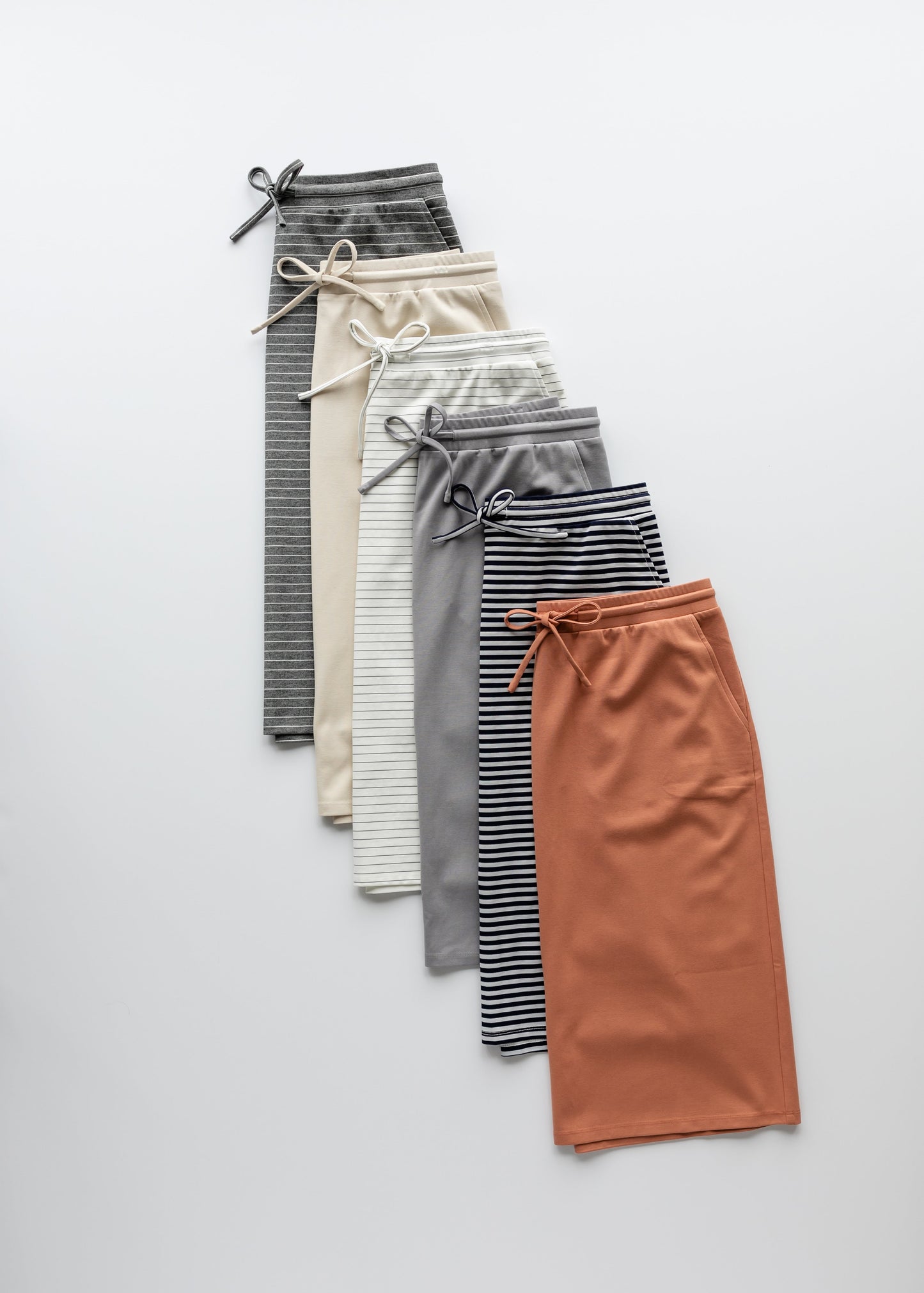 A modest salmon pink midi skirt . Featuring a a straight fit, pockets, and a drawstring waist.