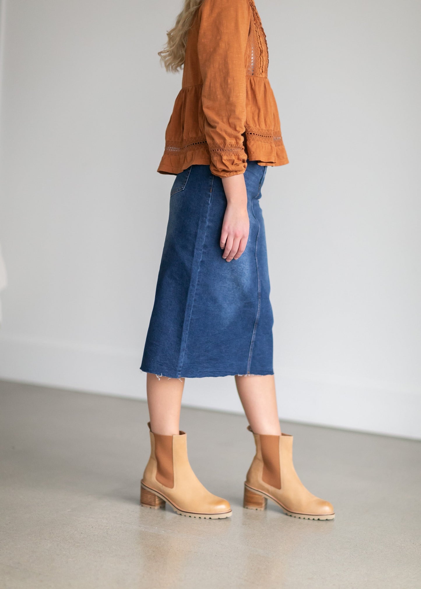 An Inherit Exclusive, the Remi Raw Hem Dark Denim Midi Skirt is cut with a modest and classic straight fit. This dark denim skirt has a raw bottom hem and will be a go-to time and time again for any occasion! The slight distressing at the hip adds fun style to your closet without any thought at being dressy or casual as it is definitely both! This skirt has awesome stretch for total comfort and no back slit while still allowing for unconstrained walking.