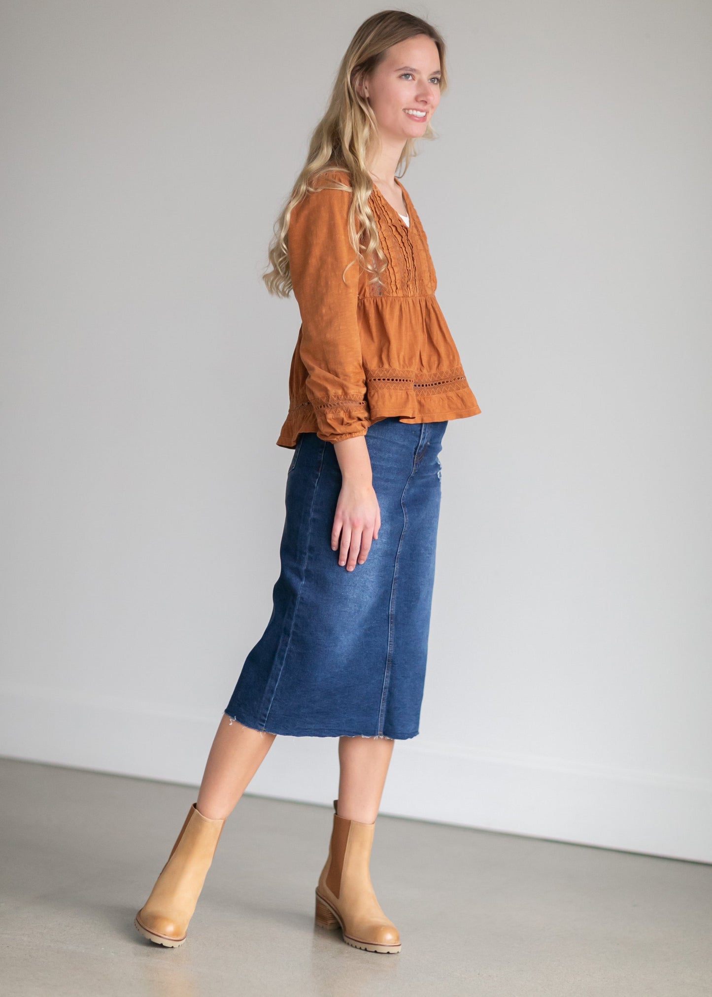 An Inherit Exclusive, the Remi Raw Hem Dark Denim Midi Skirt is cut with a modest and classic straight fit. This dark denim skirt has a raw bottom hem and will be a go-to time and time again for any occasion! The slight distressing at the hip adds fun style to your closet without any thought at being dressy or casual as it is definitely both! This skirt has awesome stretch for total comfort and no back slit while still allowing for unconstrained walking.