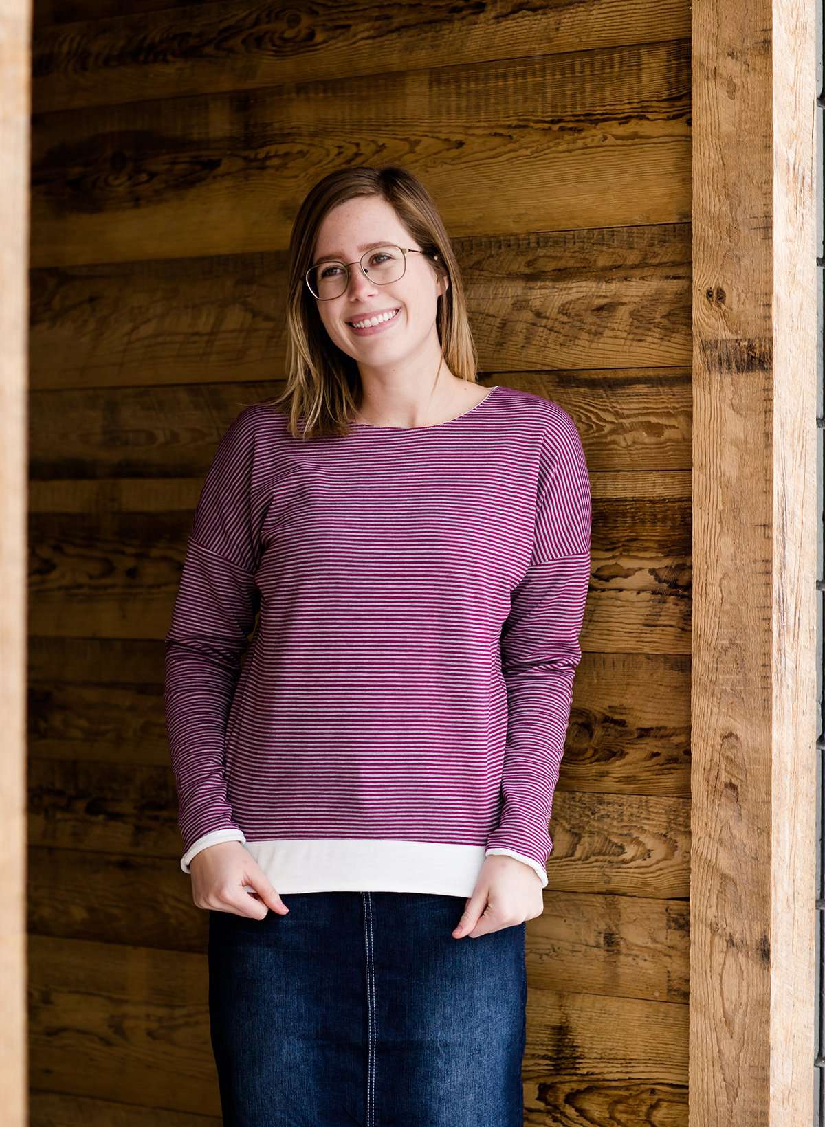 woman wearing a reversible knit top in purple and white