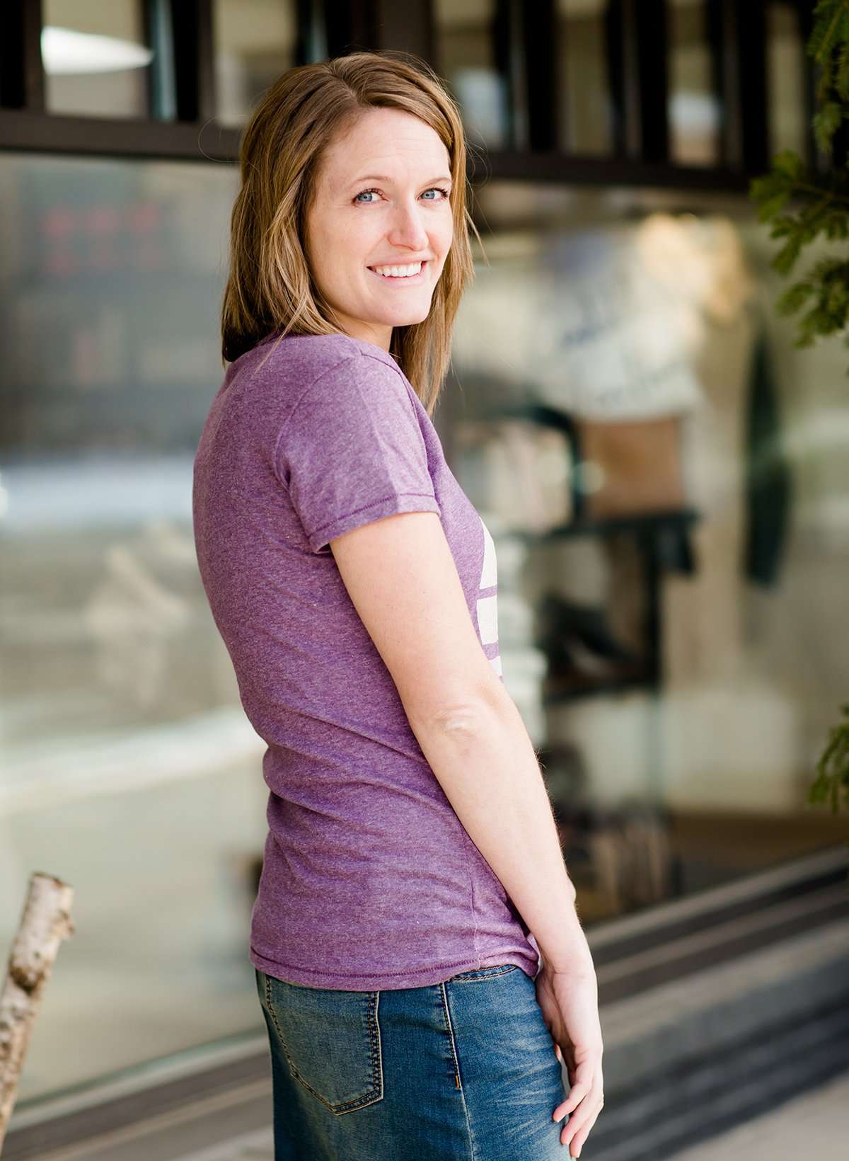 Mauve and Olive Minnesota screen printed tee shirt. These shirts are worn by a model standing in front of Inherit Clothing Company.