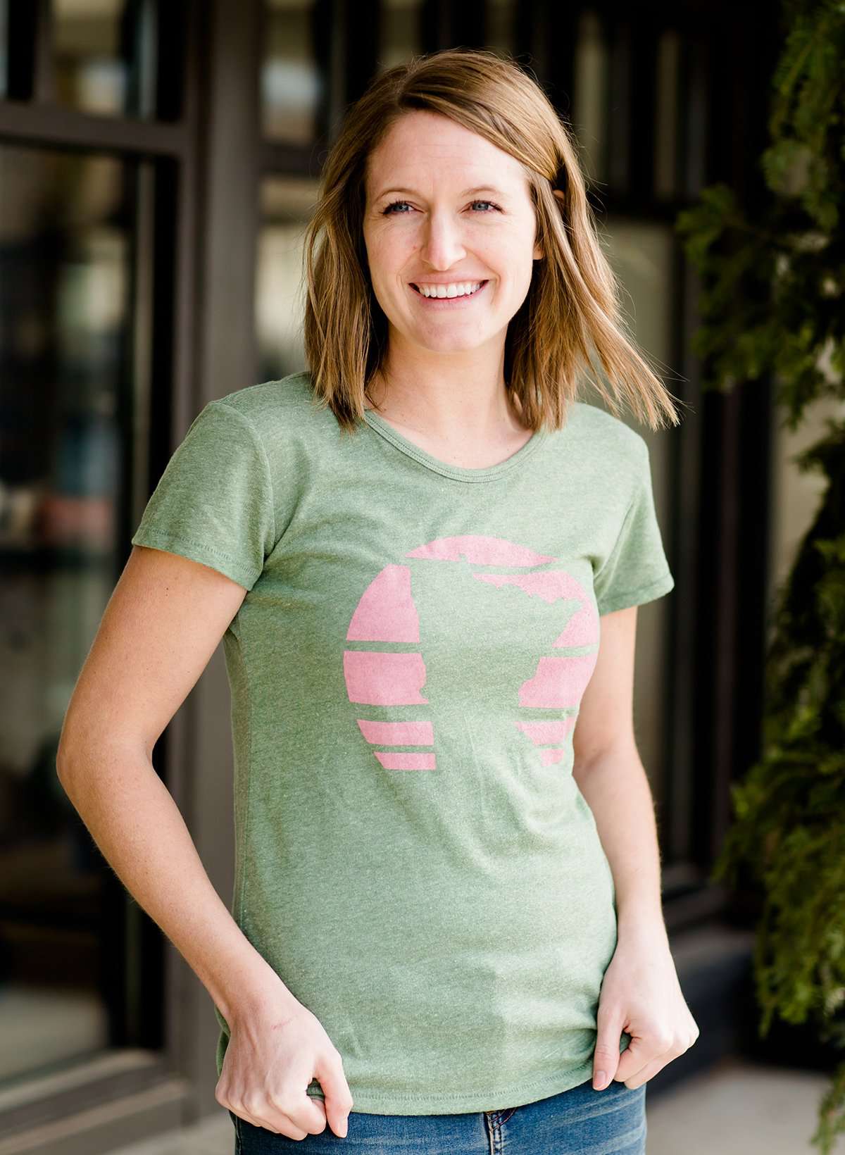 Mauve and Olive Minnesota screen printed tee shirt. These shirts are worn by a model standing in front of Inherit Clothing Company.
