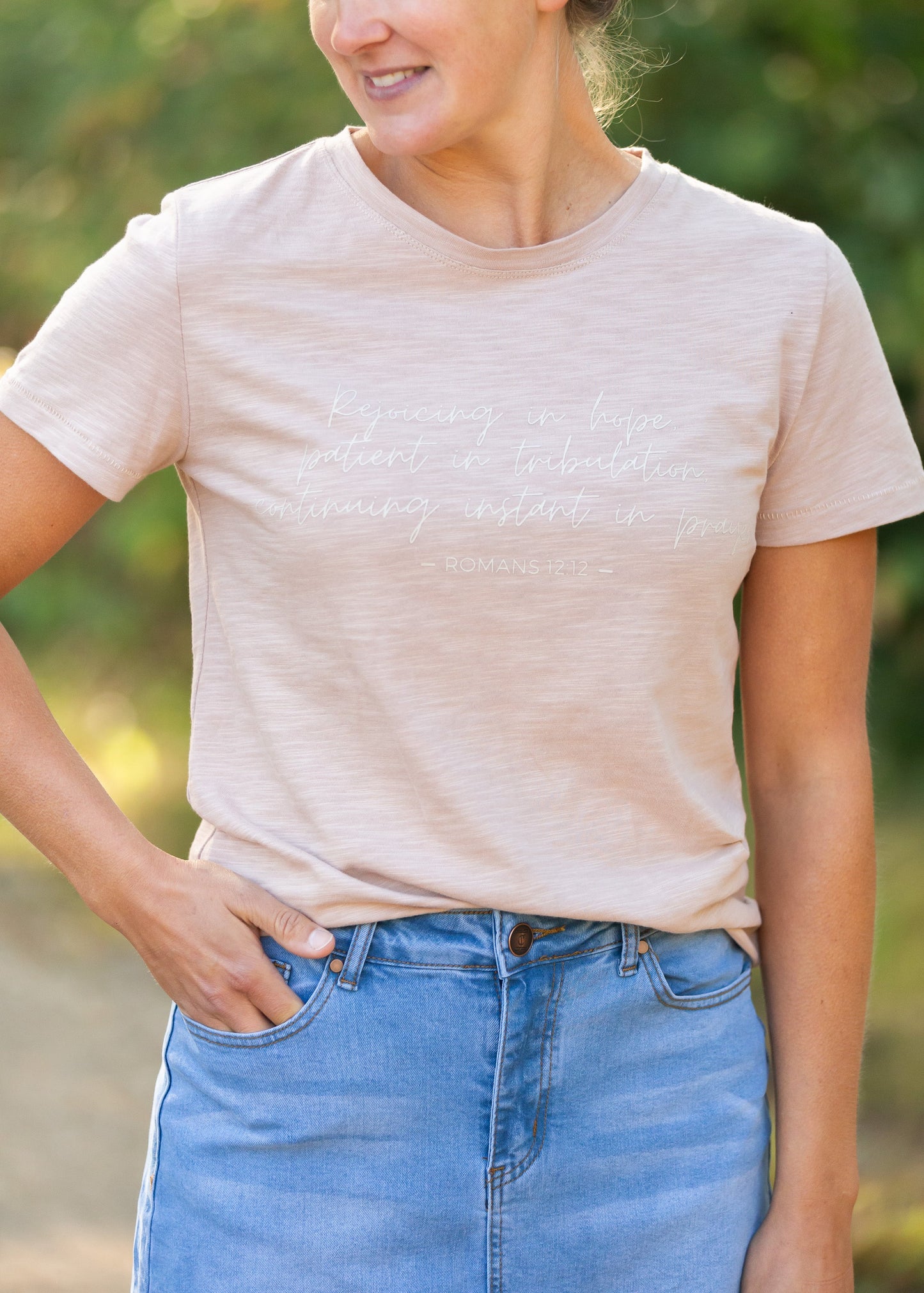 This custom Romans Graphic Tee is an Inherit Design tailored in a feminine fit. The sleeve length is a true short sleeve that will go with anything. It is a pink with a slight heathered look that isn't see-through! The white writing on the front says "Rejoicing in hope, patient in tribulation; continuing instant in prayer." - Romans 12:12 for a daily reminder in your walk with the Lord!