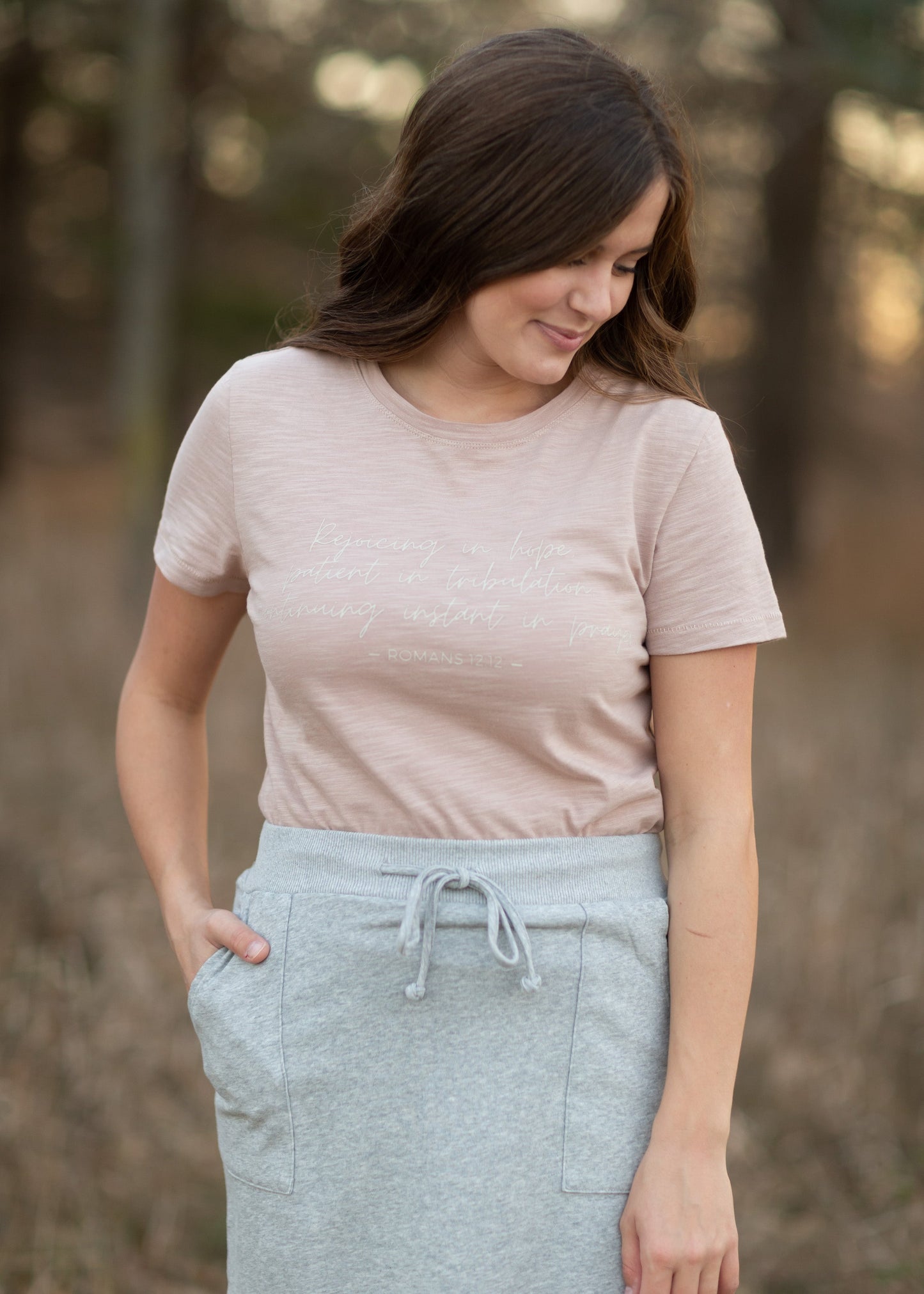 This custom Romans Graphic Tee is an Inherit Design tailored in a feminine fit. The sleeve length is a true short sleeve that will go with anything. It is a pink with a slight heathered look that isn't see-through! The white writing on the front says "Rejoicing in hope, patient in tribulation; continuing instant in prayer." - Romans 12:12 for a daily reminder in your walk with the Lord!