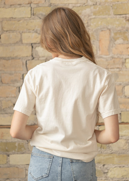 Cream crewneck tee featuring floral patchwork flag design