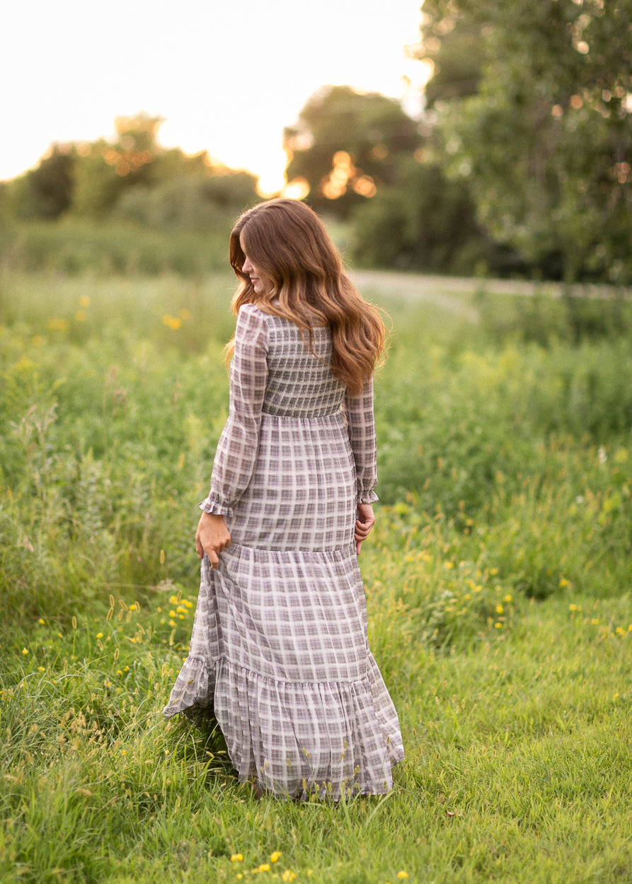 Back of the taupe plaid maxi dress showing the smocked bodice and tiered skirt.