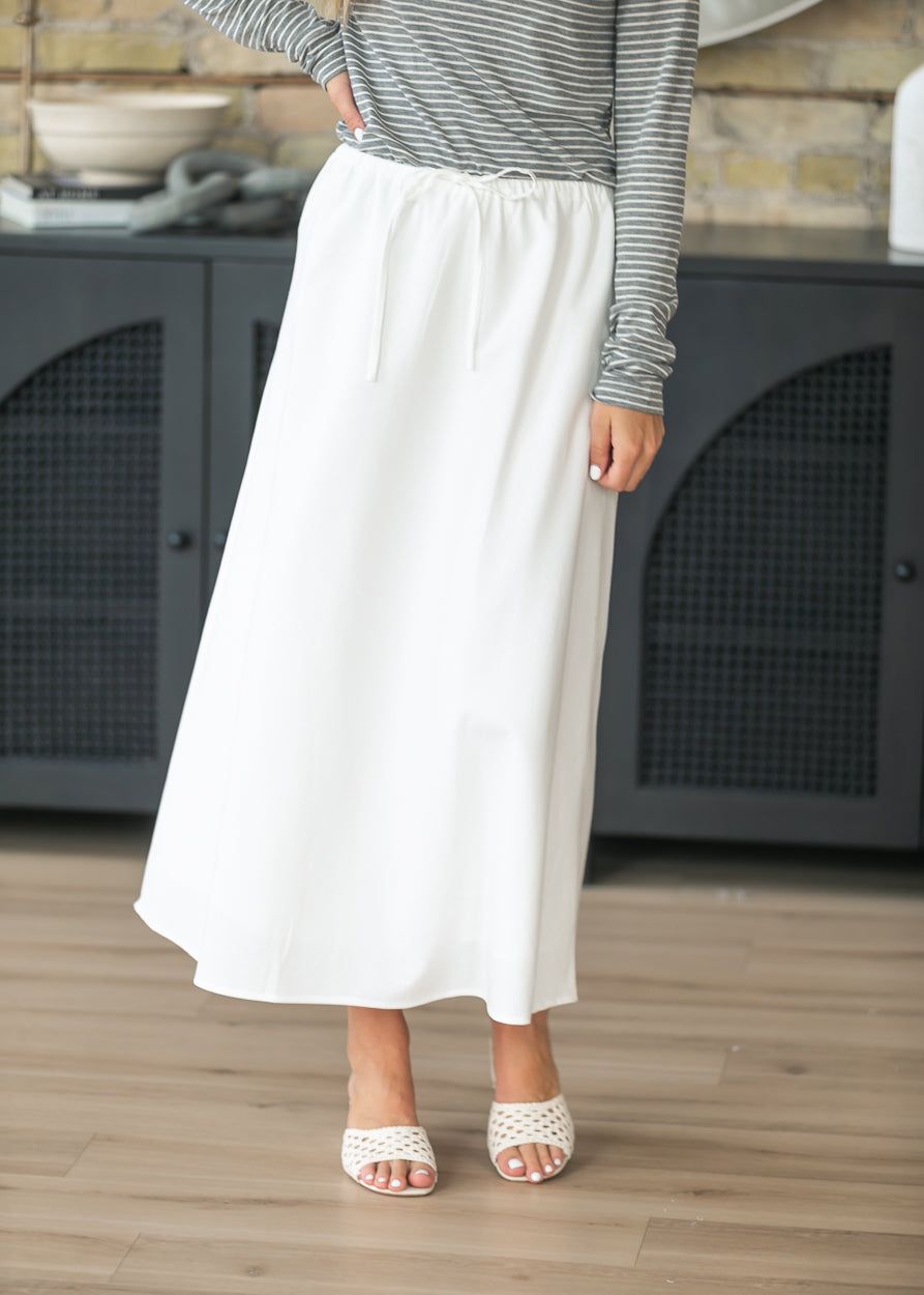 Close-up of the ivory drawstring waistband on a lined straight midi skirt.