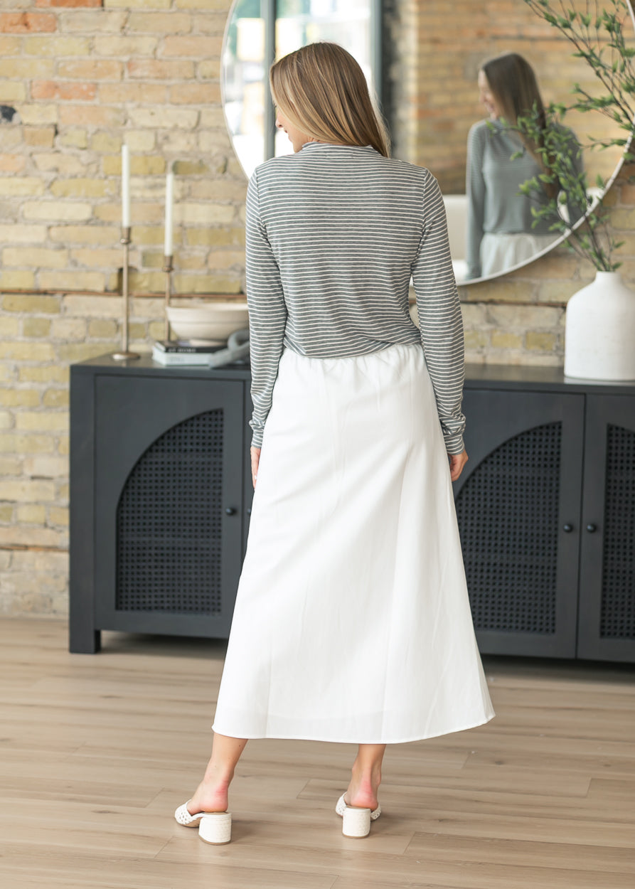 Back of the soft ivory midi skirt showing the clean straight silhouette.