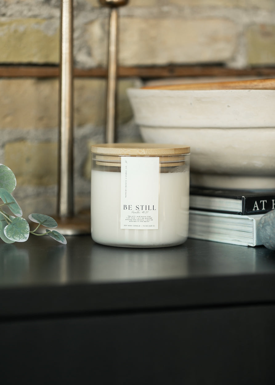 Be Still Lavender and Sage 15 oz. soy candle in a clear glass jar with white wax and natural wood lid.