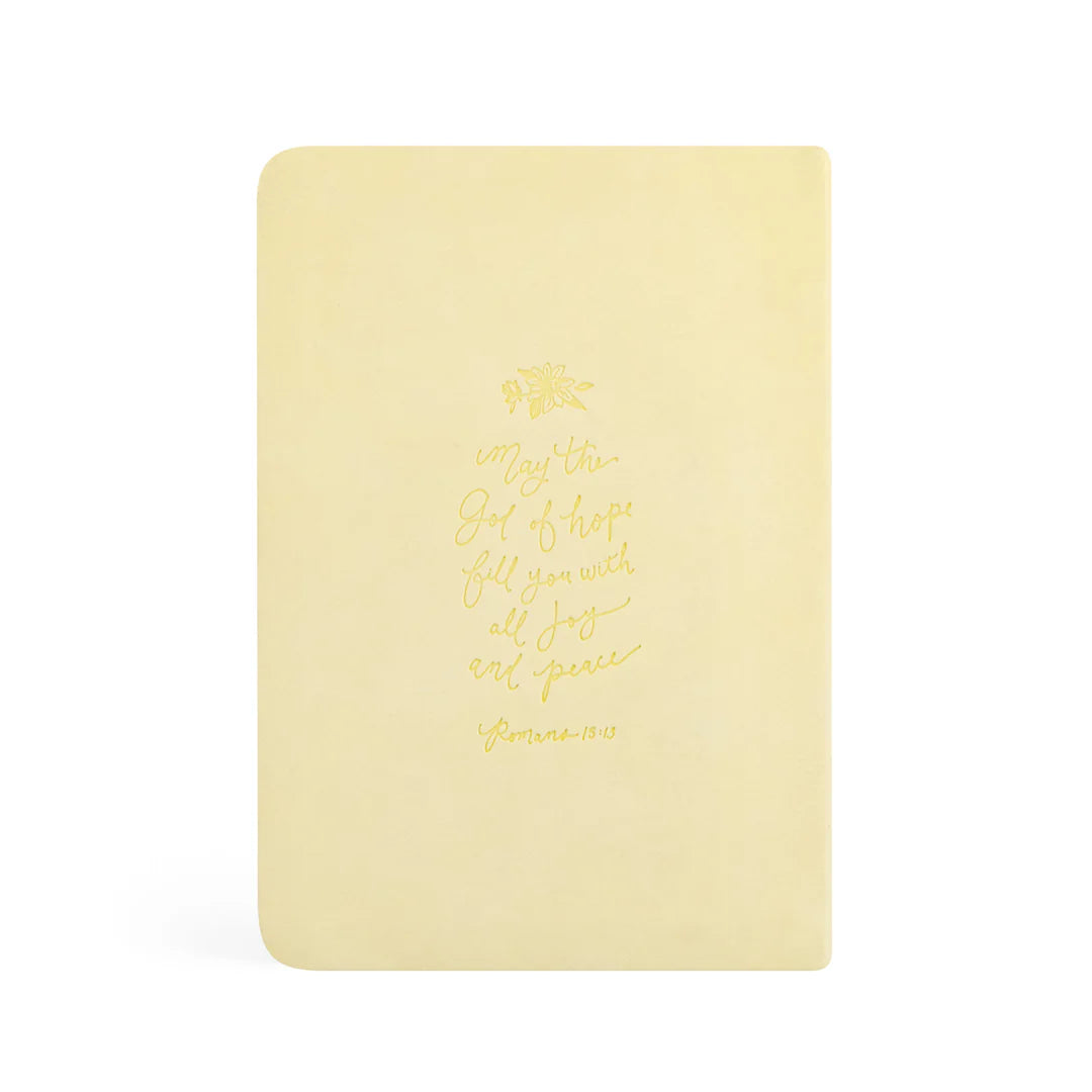 Back cover of the butter-yellow Belfast notebook with a gold-foil Romans 15:13 verse and a small daffodil sprig.