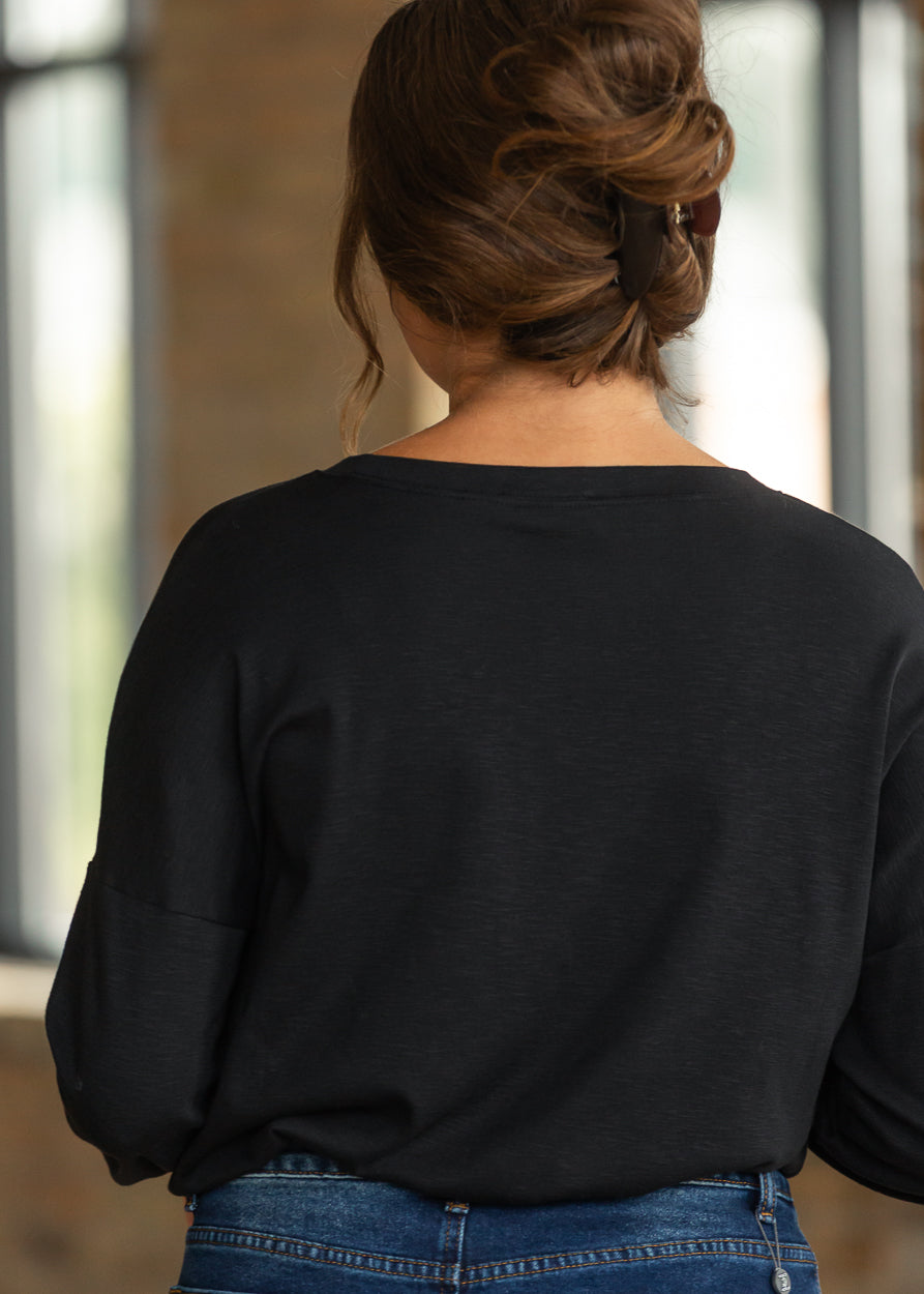 Back of black cotton modal long sleeve top showing the relaxed fit and drop shoulder design.