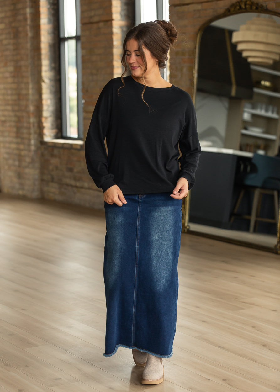 Black cotton modal slub long sleeve top with a loose fit and dark wash denim maxi skirt.