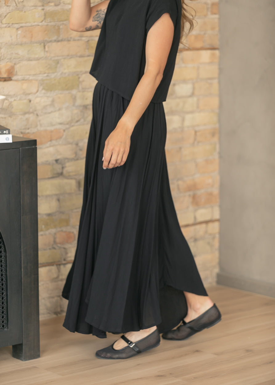 Black gauze top with cap sleeves and relaxed drape