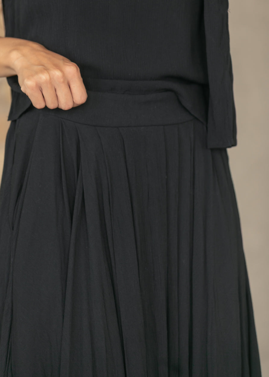Close view of black elastic waistband and flowing maxi skirt