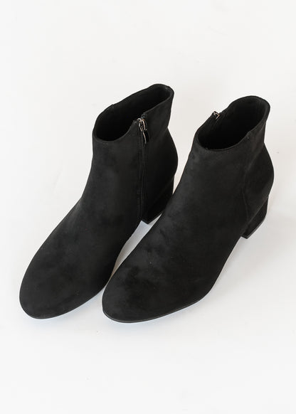 Black Corkys ankle boots with pointed toes, low block heels, and sleek ankle-height silhouette.