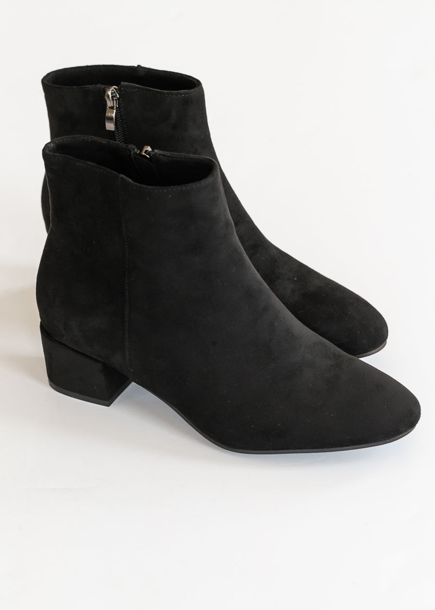 Black pointed toe ankle boots with low block heels and side zipper detail.