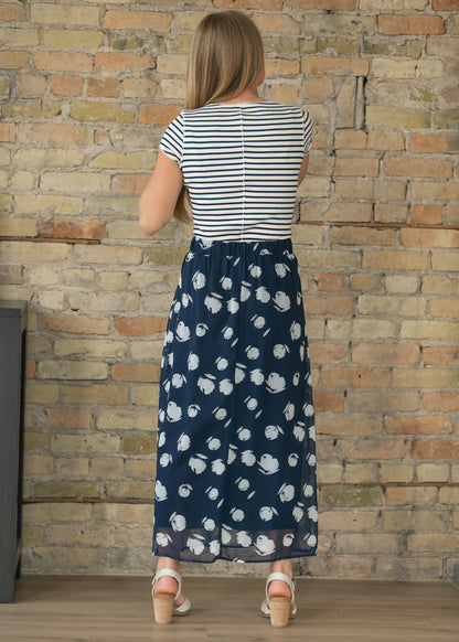 Free People striped cardigan styled with a navy watercolor print midi skirt and heeled sandals