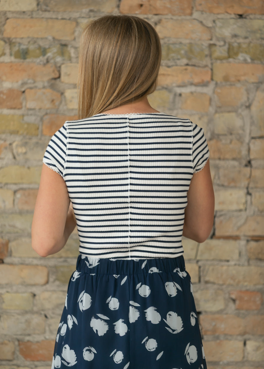 Back view of navy and white striped ribbed cardigan showing fitted waist-length silhouette