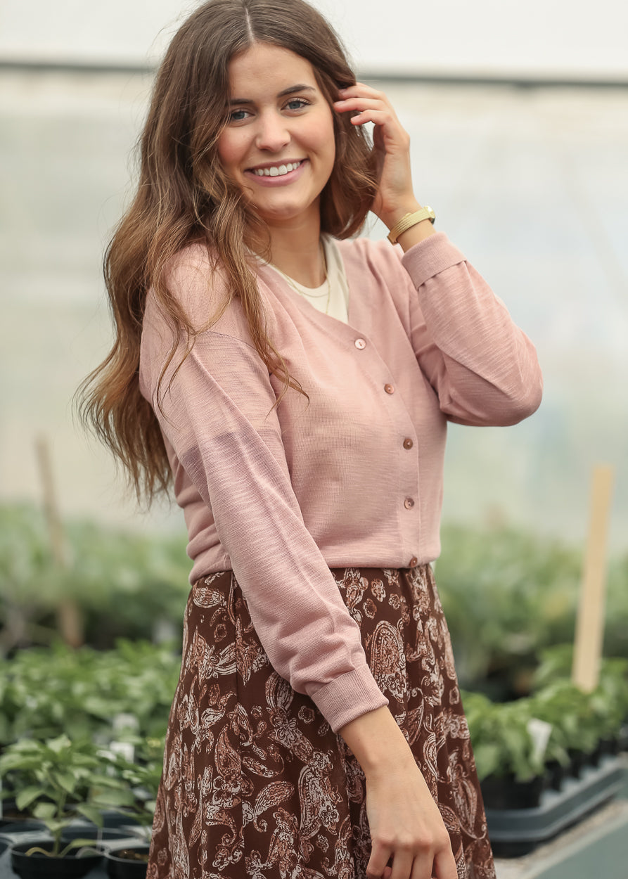 Soft mauve cardigan with button front and lightweight long sleeves styled with a paisley skirt