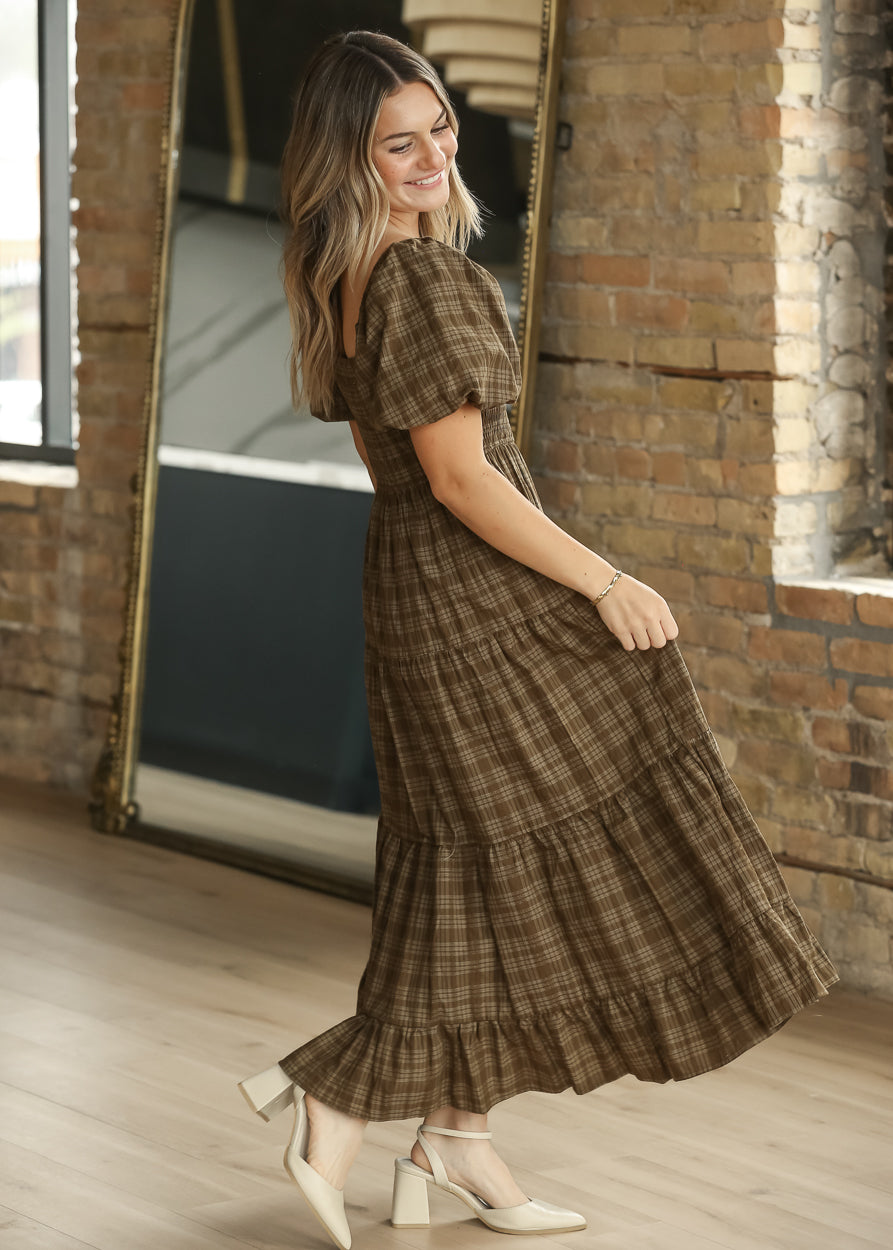 Brown plaid square neck midi dress with smocked bodice, puff sleeves, and tiered skirt.