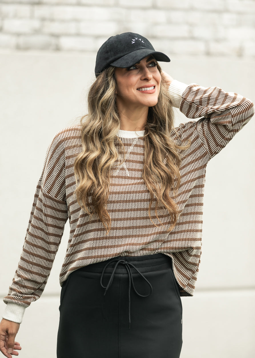 Brown ribbed pullover with cream trim styled for an easy casual outfit. 
