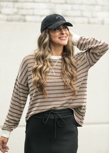 Brown ribbed pullover with cream trim styled for an easy casual outfit. 