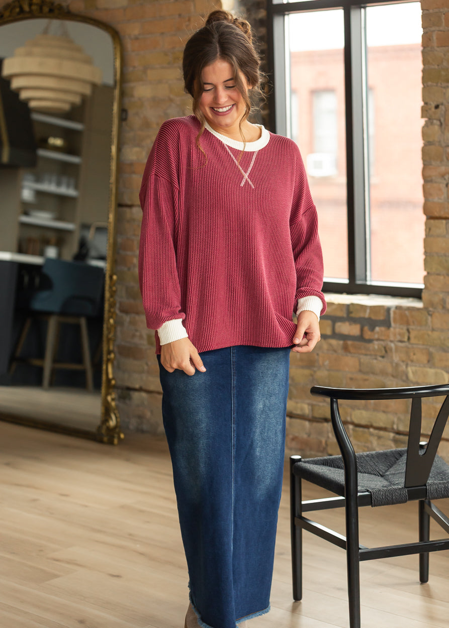 Burgundy ribbed long sleeve top with cream trim and relaxed drop shoulders.