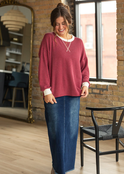 Burgundy ribbed long sleeve top with cream trim and relaxed drop shoulders.