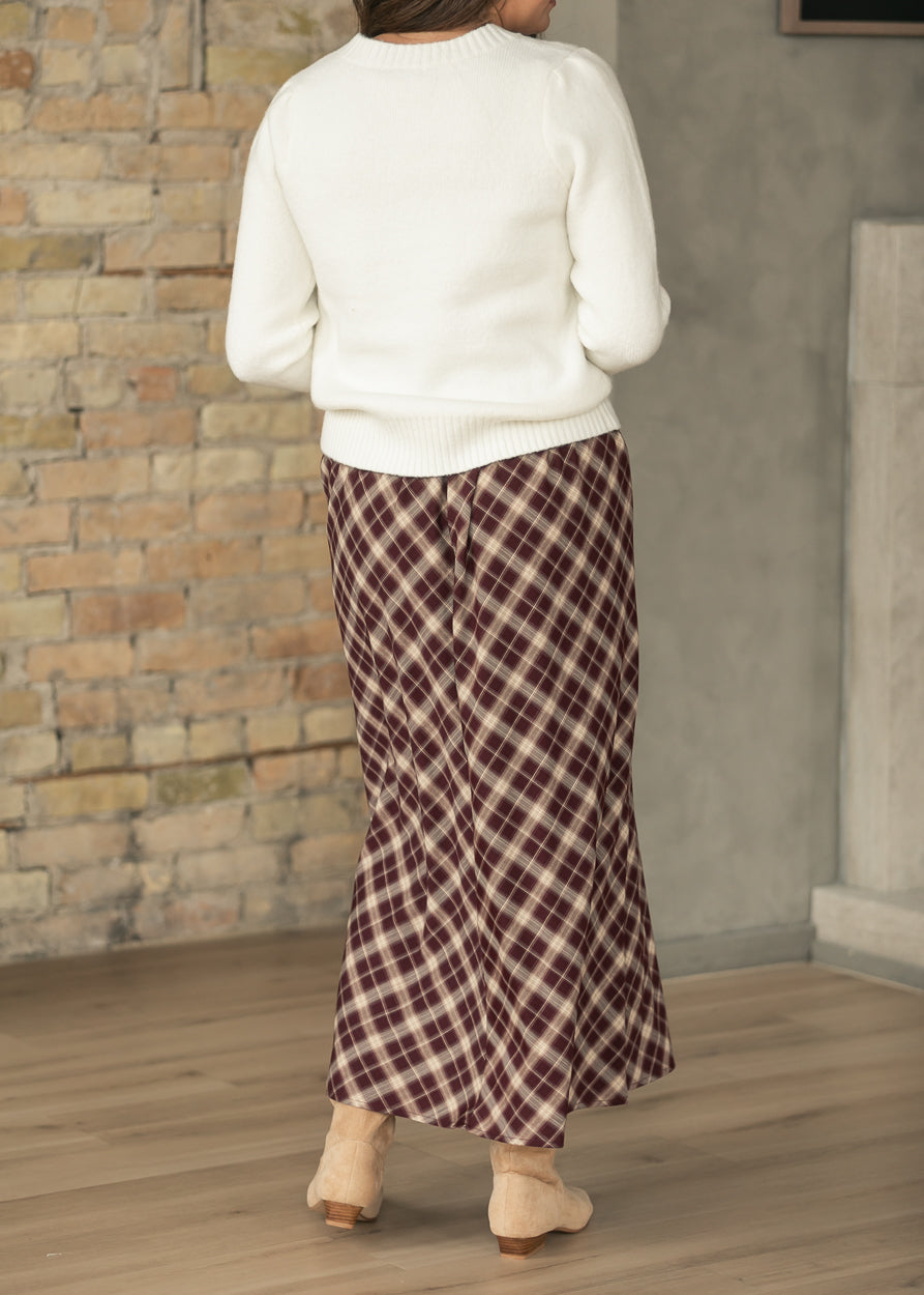 Back of burgundy plaid A-line midi skirt showing flowing silhouette and 36-38 inch length.