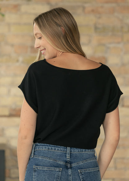 Back view of black knit top showing relaxed fit and clean silhouette.