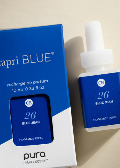Close-up of Capri Blue Blue Jean Pura refill bottle and branded fragrance packaging