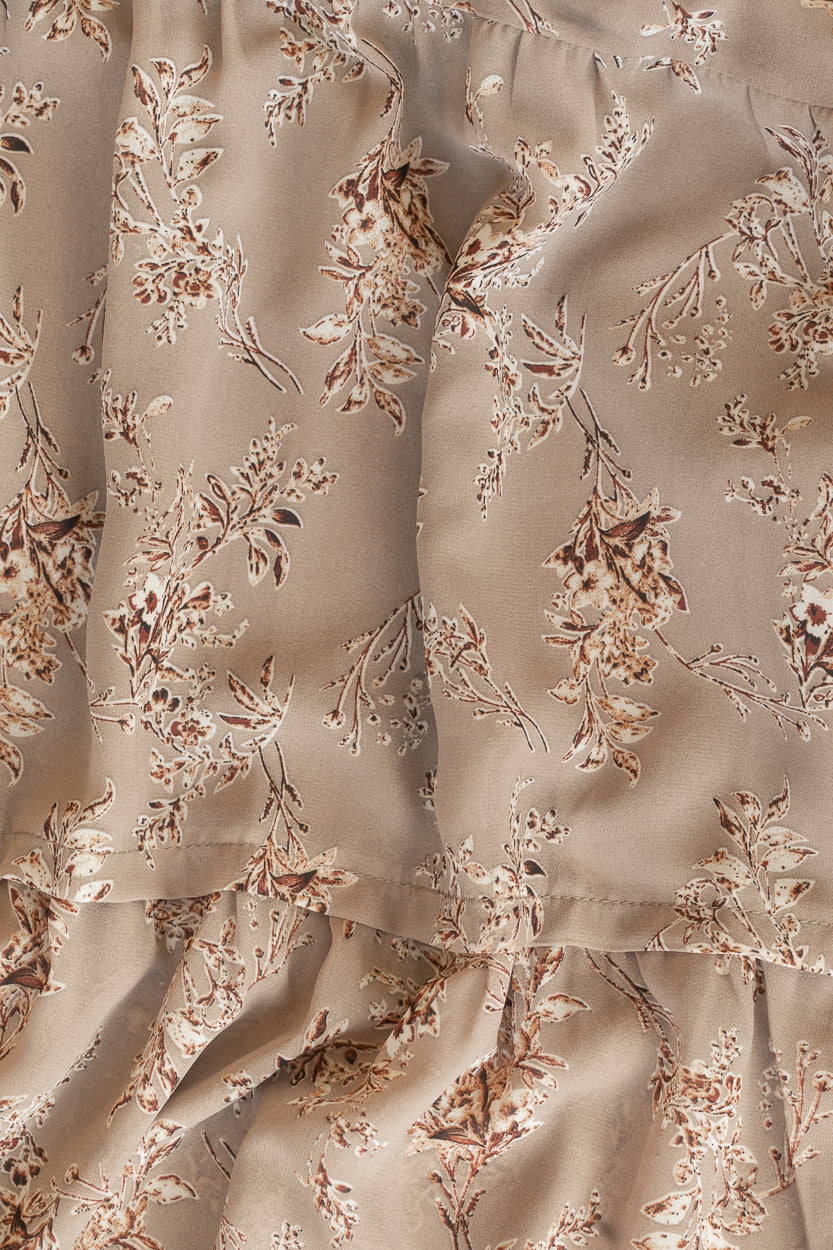 Close-up of brown floral polyester fabric and delicate allover floral print.