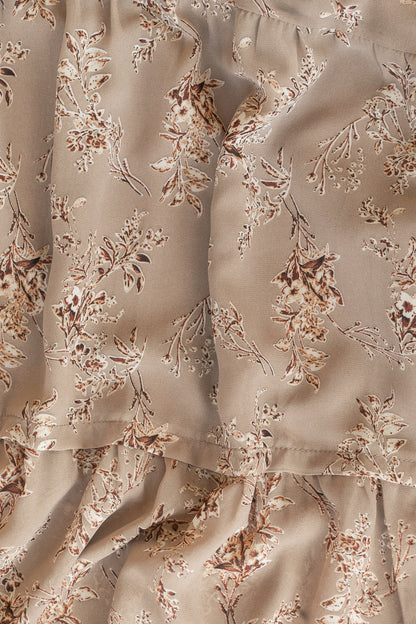 Close-up of brown floral polyester fabric and delicate allover floral print.