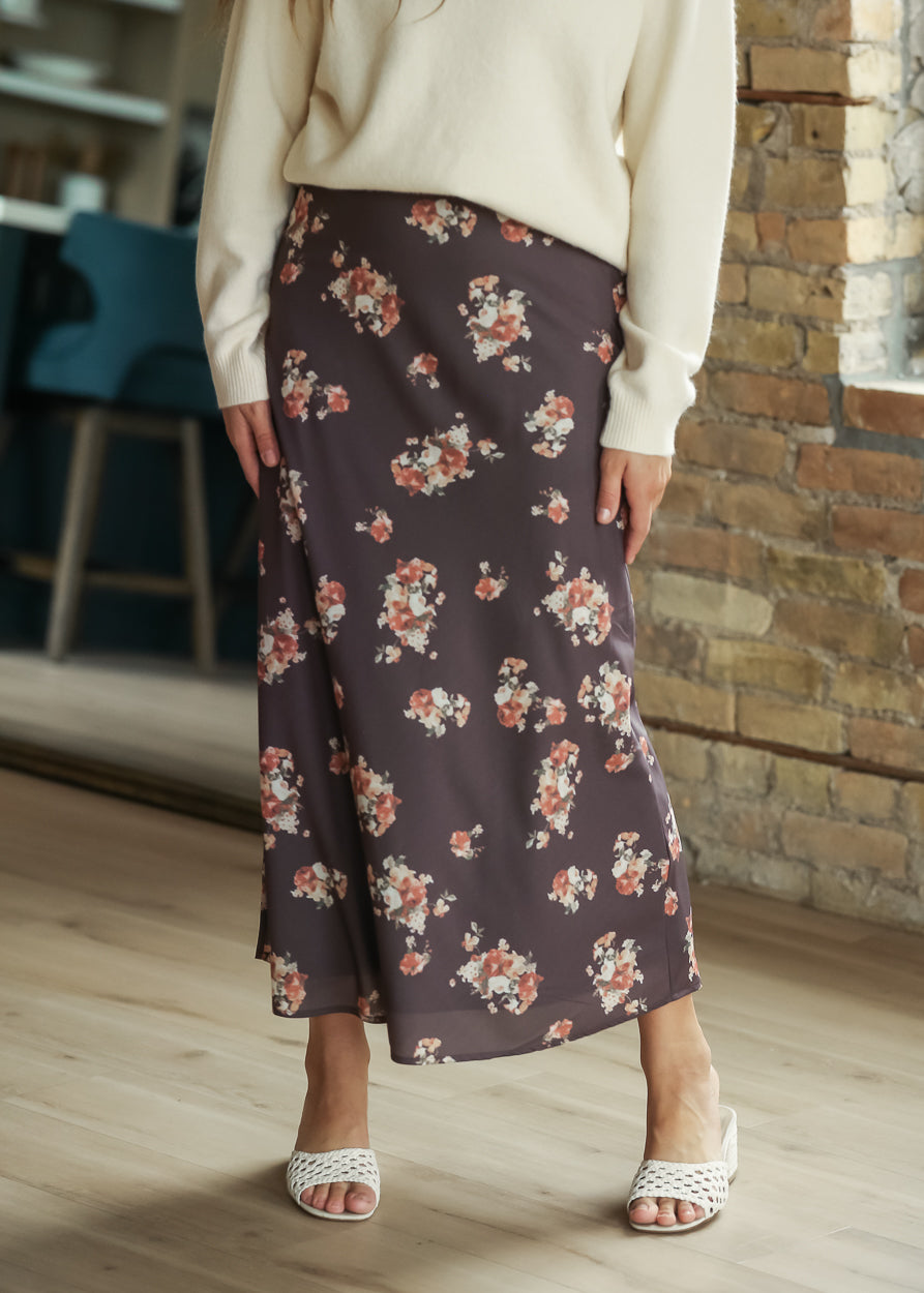 Charcoal multi floral midi skirt styled with a cream sweater and white heels