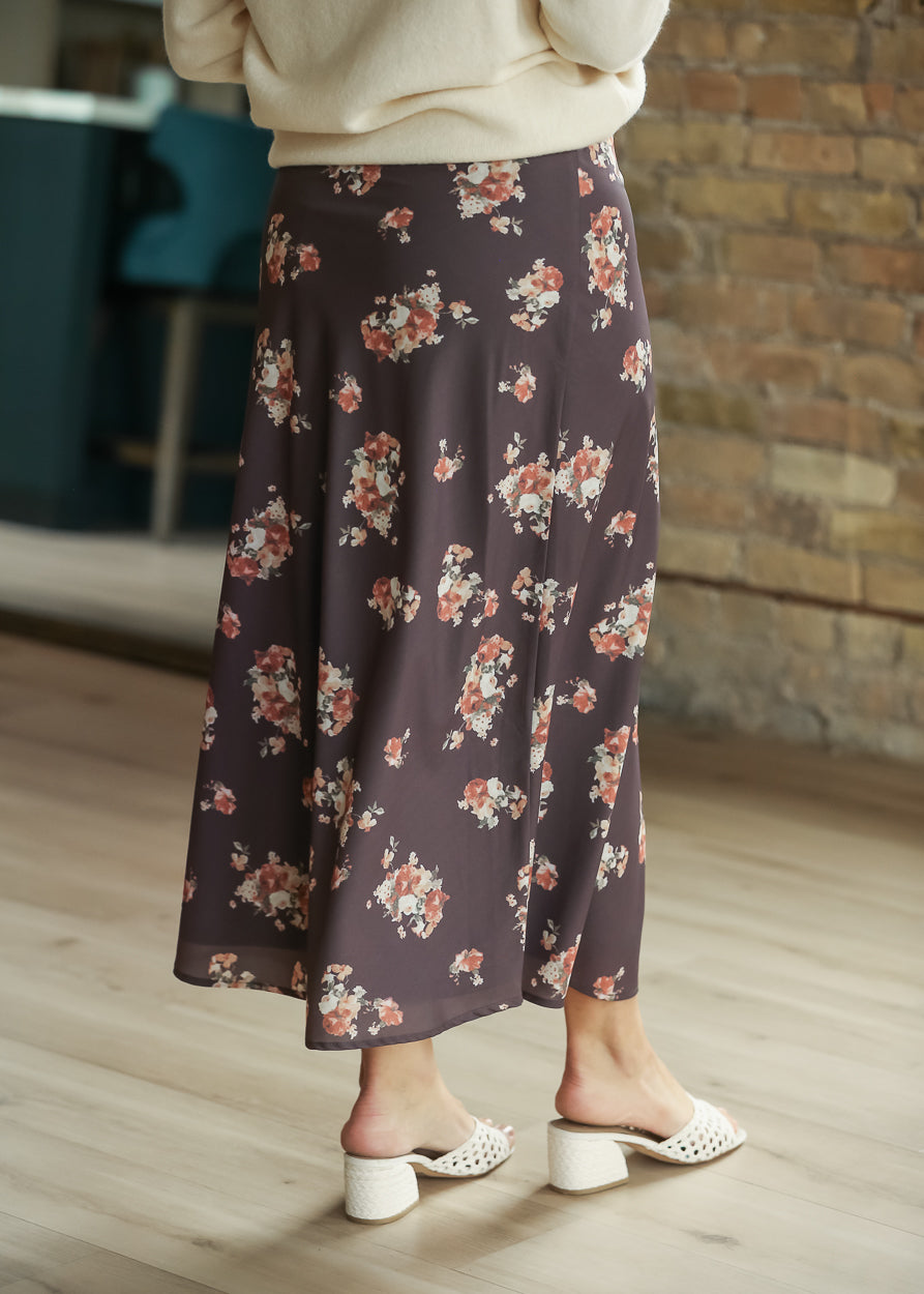 Back view of charcoal multi floral midi skirt showing the flowy ankle-length silhouette