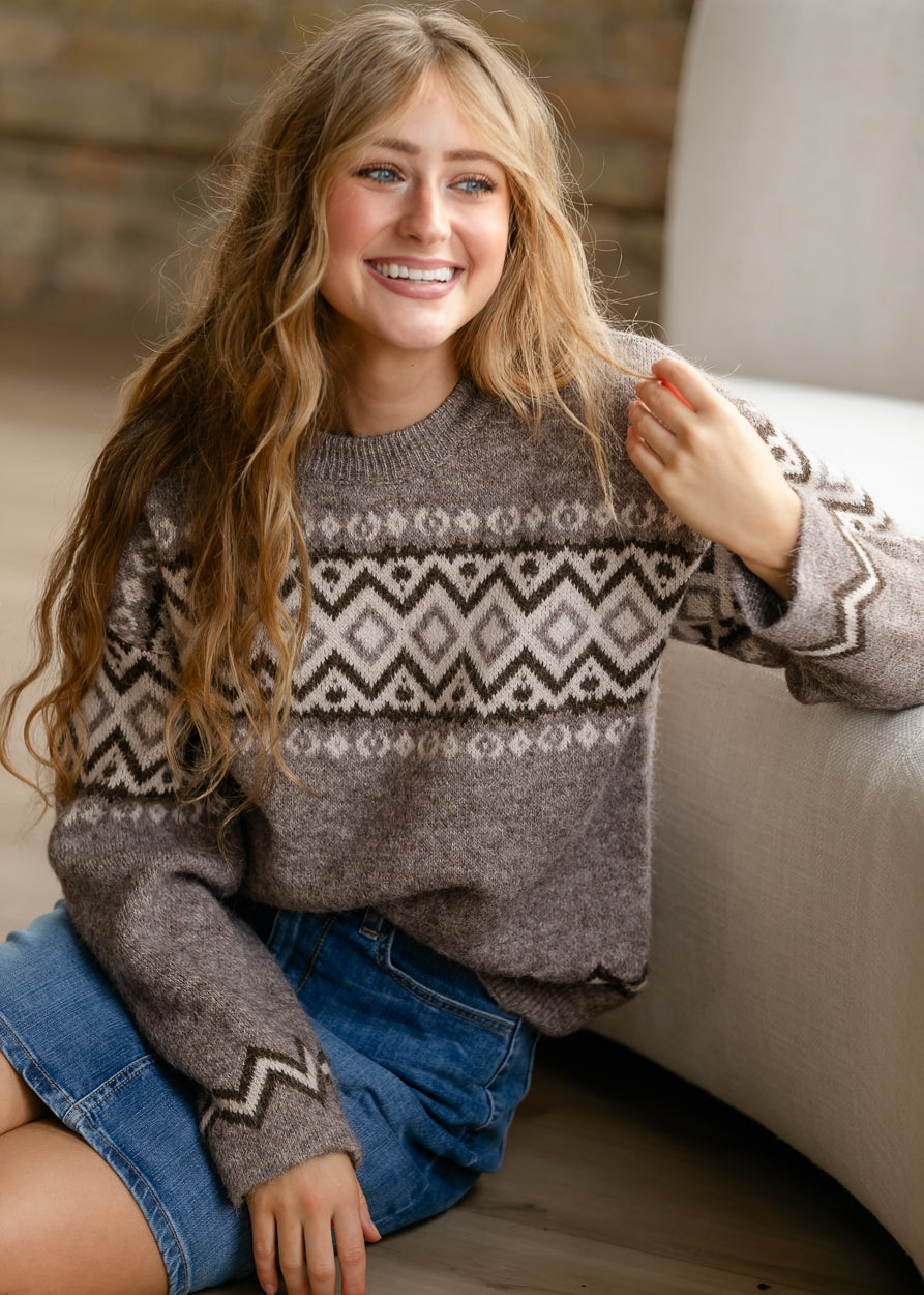 Taupe long sleeve knit sweater with loose fit, ribbed neckline, and geometric pattern.