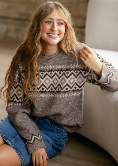 Taupe long sleeve knit sweater with loose fit, ribbed neckline, and geometric pattern.