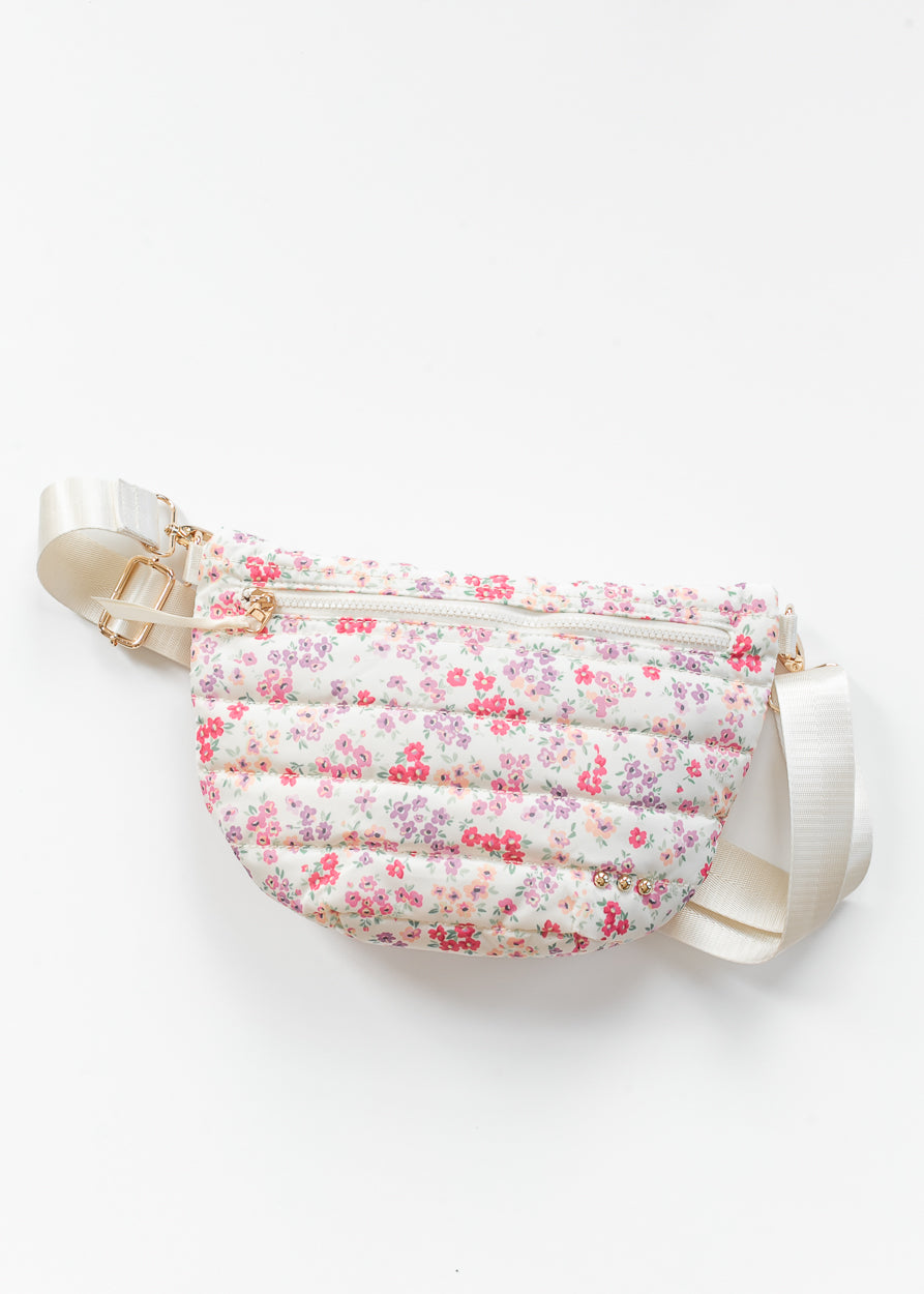 Close-up_of_floral_quilted_belt_bag_with_cream_strap_and_gold-tone_hardware_details.
