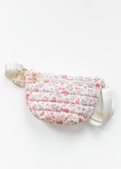 Close-up_of_floral_quilted_belt_bag_with_cream_strap_and_gold-tone_hardware_details.