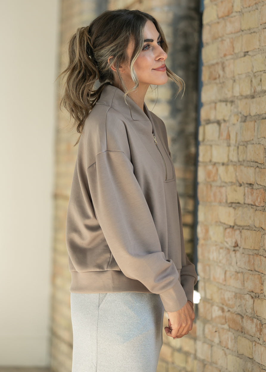Side view of the cropped cocoa sweatshirt showing its relaxed, loose fit.