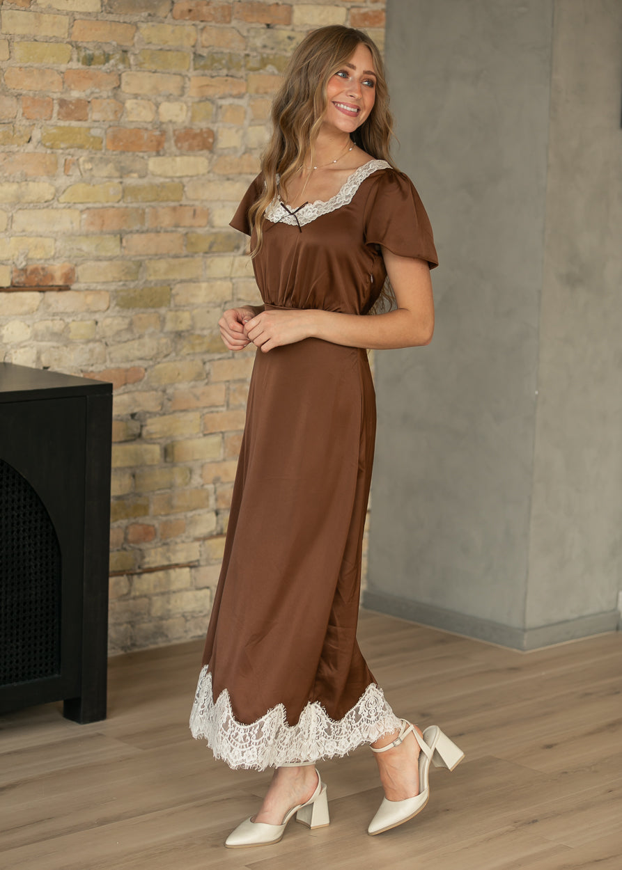 Chocolate brown midi dress with cream lace neckline and scalloped lace hem, styled with cream heels.