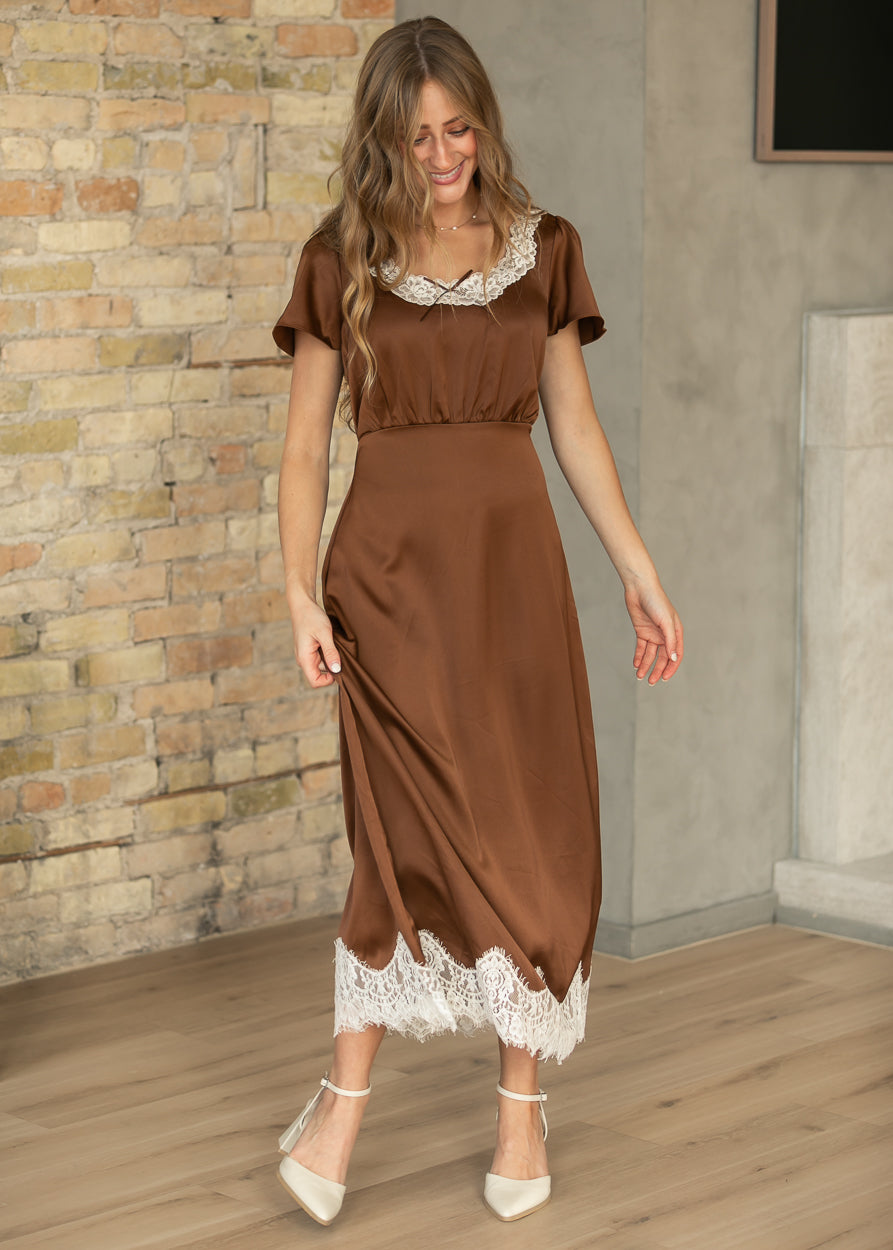 Chocolate brown short sleeve midi dress with contrast cream lace trim and a defined waist.