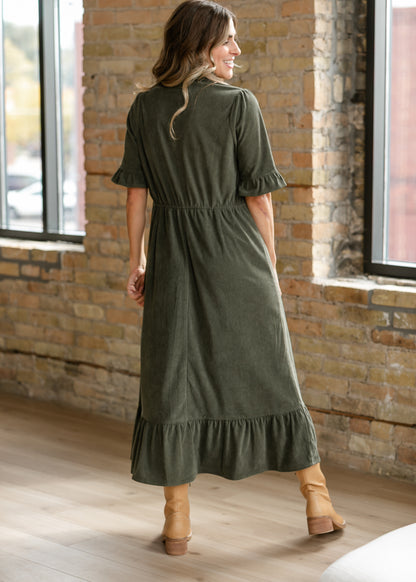 Back of olive corduroy midi dress showing the defined waist, half sleeves, and ruffle hem.