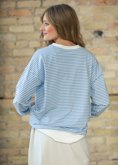 Cornflower blue mini striped crewneck sweater with white ribbed trim and relaxed drop shoulders.