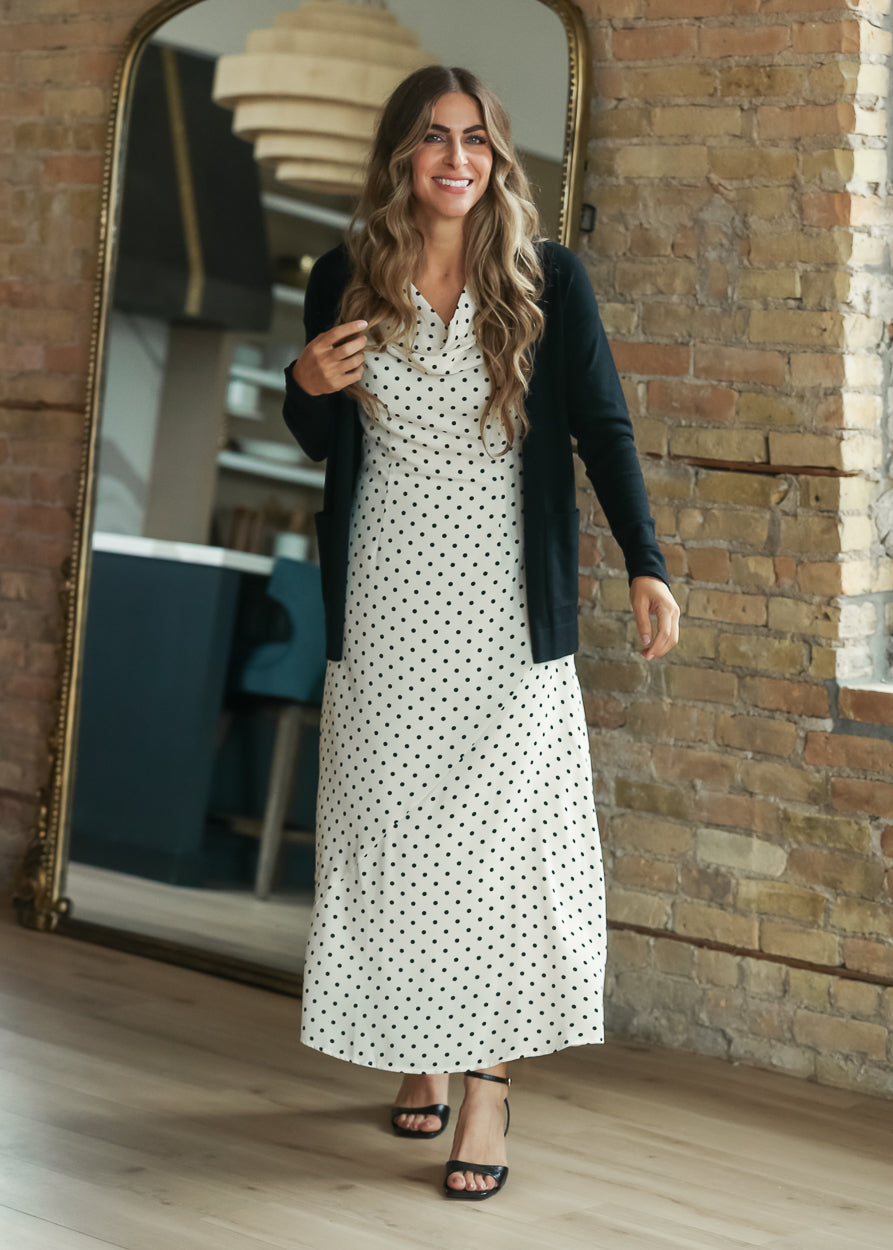Cream polka-dot midi dress layered with a black open-front cardigan