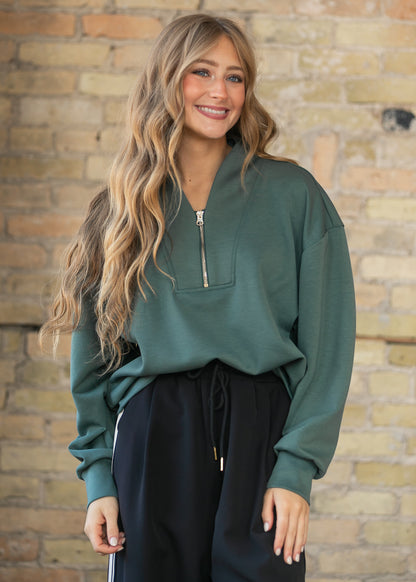 Front view of the dark forest quarter zip sweatshirt highlighting the notched collar and zip placket.