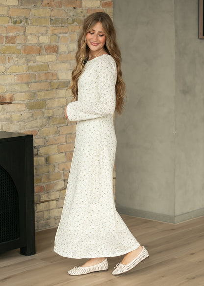 Side view of cream floral button-front maxi dress showing semi-fitted shape and long sleeves.