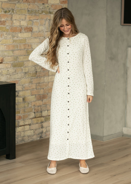 Cream floral long sleeve maxi dress with dark button-front detail and tiny pink and green floral print.