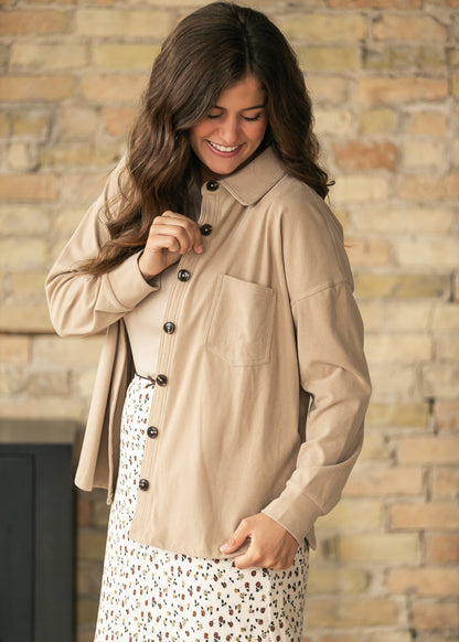 Taupe collared patch pocket cardigan worn open with a cream floral maxi skirt.