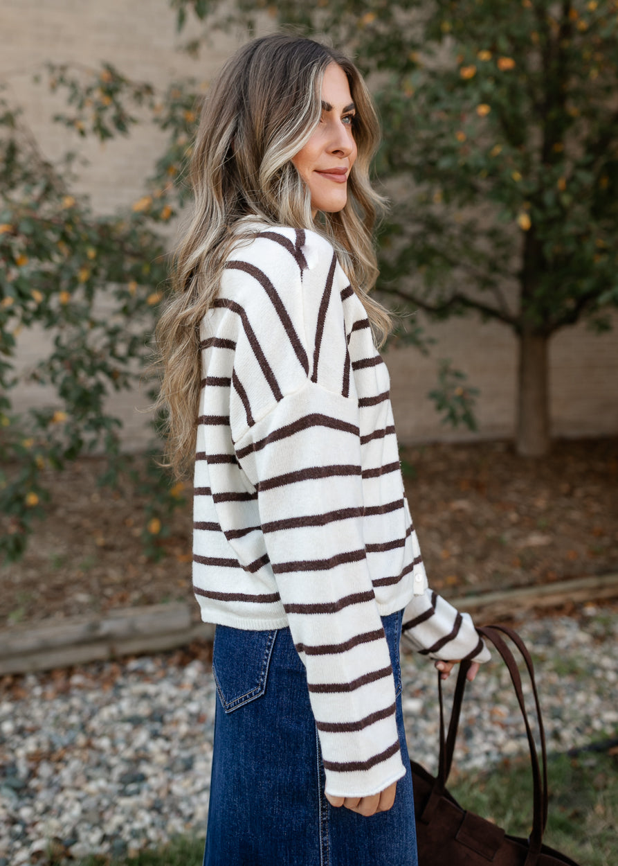Side view of the striped Piper cardigan highlighting the button placket and ribbed cuff detail.